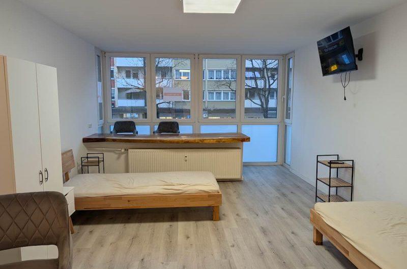 Großer, lichtdurchfluteter Wohnbereich der 29m² Wohnung in Nürnberg mit Blick auf die Fenster-Loggia.