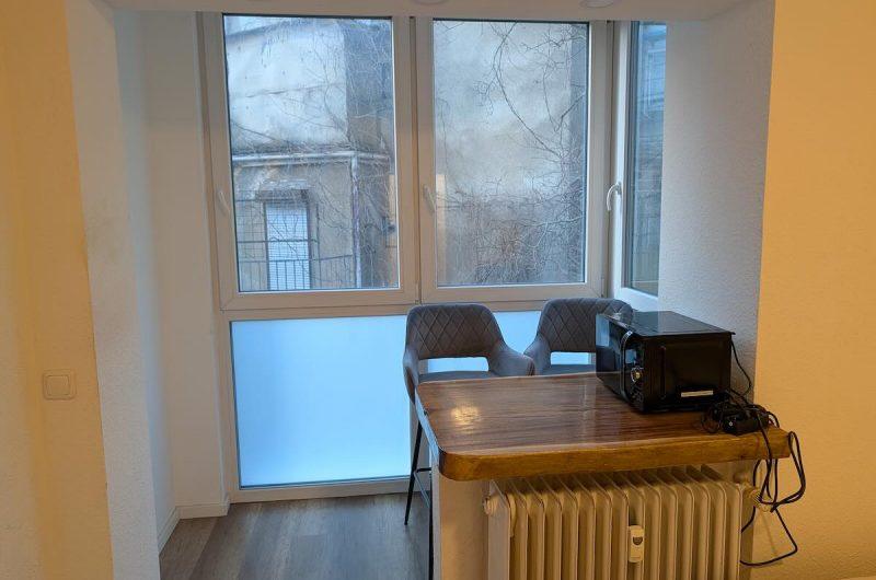 Heller, integrierter Wintergarten mit Sitzgelegenheit und Blick nach draußen.