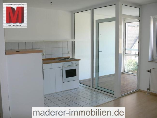 Blick vom Wohnbereich auf den verglasten Wintergarten und die Heizkörper.