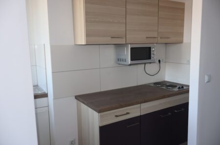 Moderne Einbauküche mit dunklen Fronten und viel Stauraum in einer Nürnberger Wohnung.