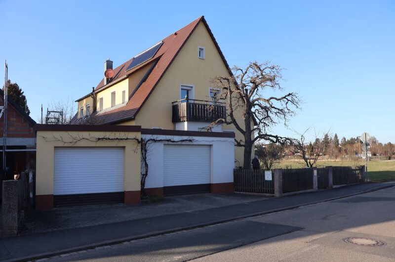 Außenansicht des Zweifamilienhauses in Oberasbach mit Garage und Einfahrt.